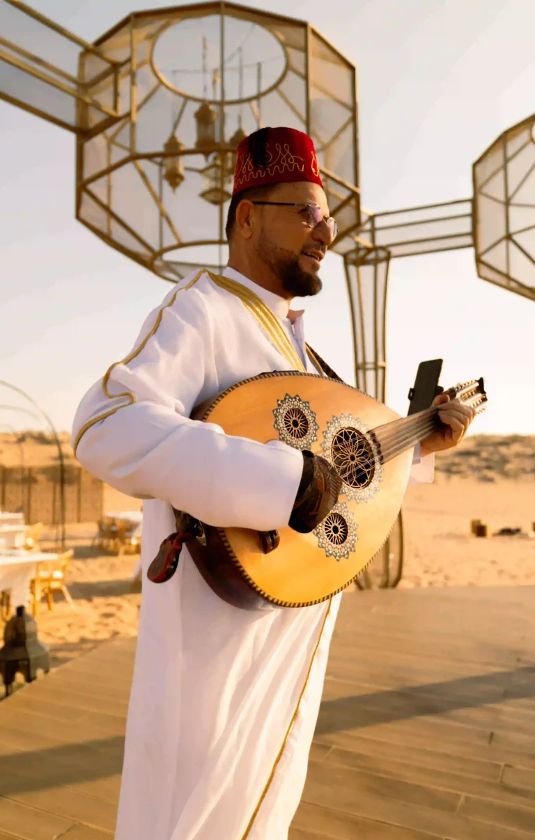 Live entertainment with an oud player performing for guests at a desert Ramadan Nights dinner by Nara