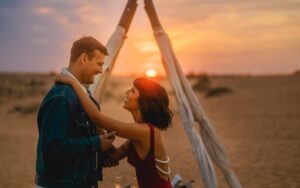 A romantic couple looking at each other in the Dubai desert