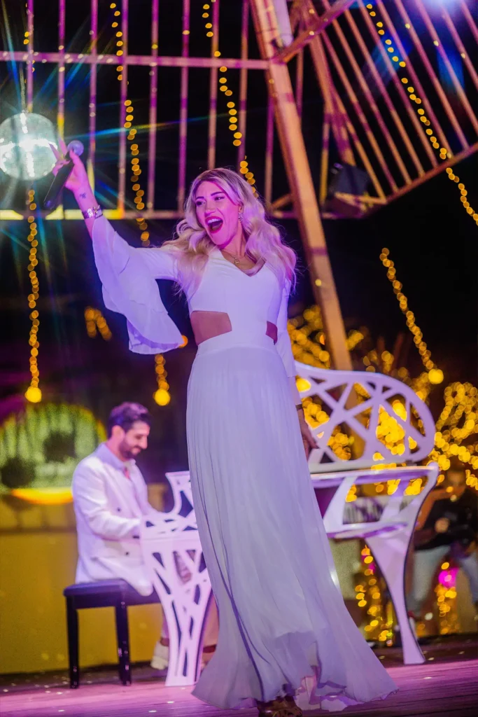 Live singer performing on stage during a milestone celebration event.