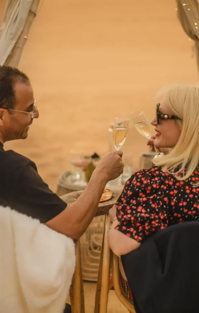 Champagne glasses prepared for a Valentine’s Day celebration in an intimate desert setting.