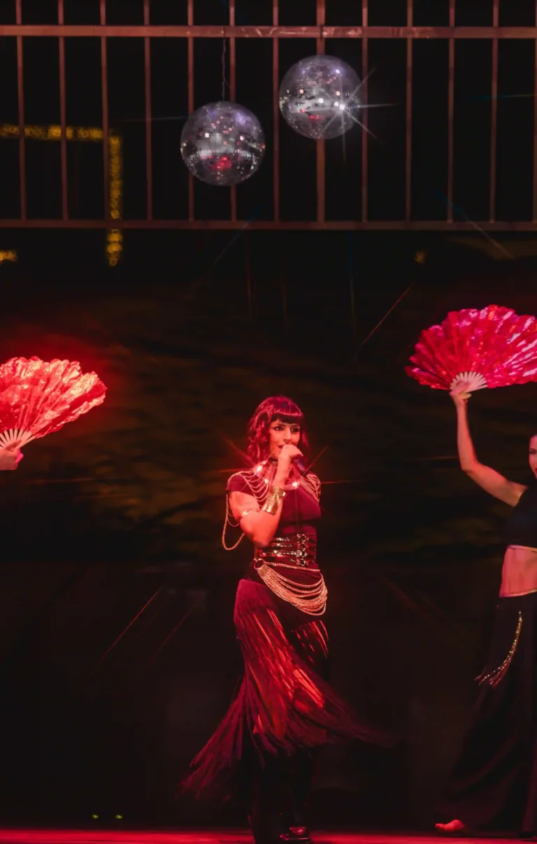Dancers in red costumes performing in the desert as part of a Valentine’s Day experience.