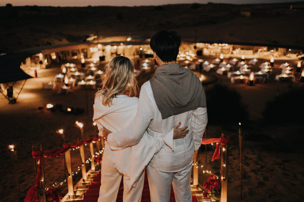 A couple looking over the Sonara Camp beneath the stars in Dubai. 