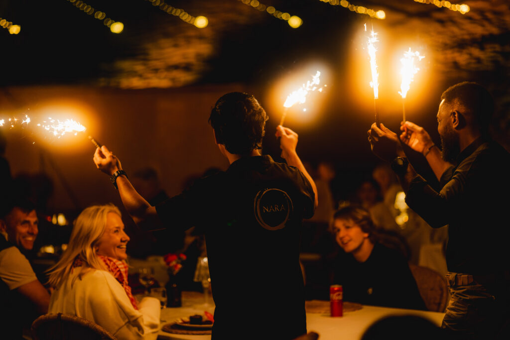 A family celebrating a birthday at Sonara Camp in Dubai. 