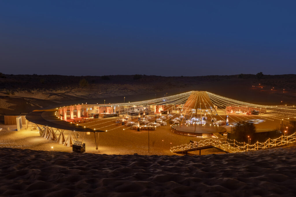 Sonara Camp at night, nestled inside the Dubai Desert Conversation Reserve. 